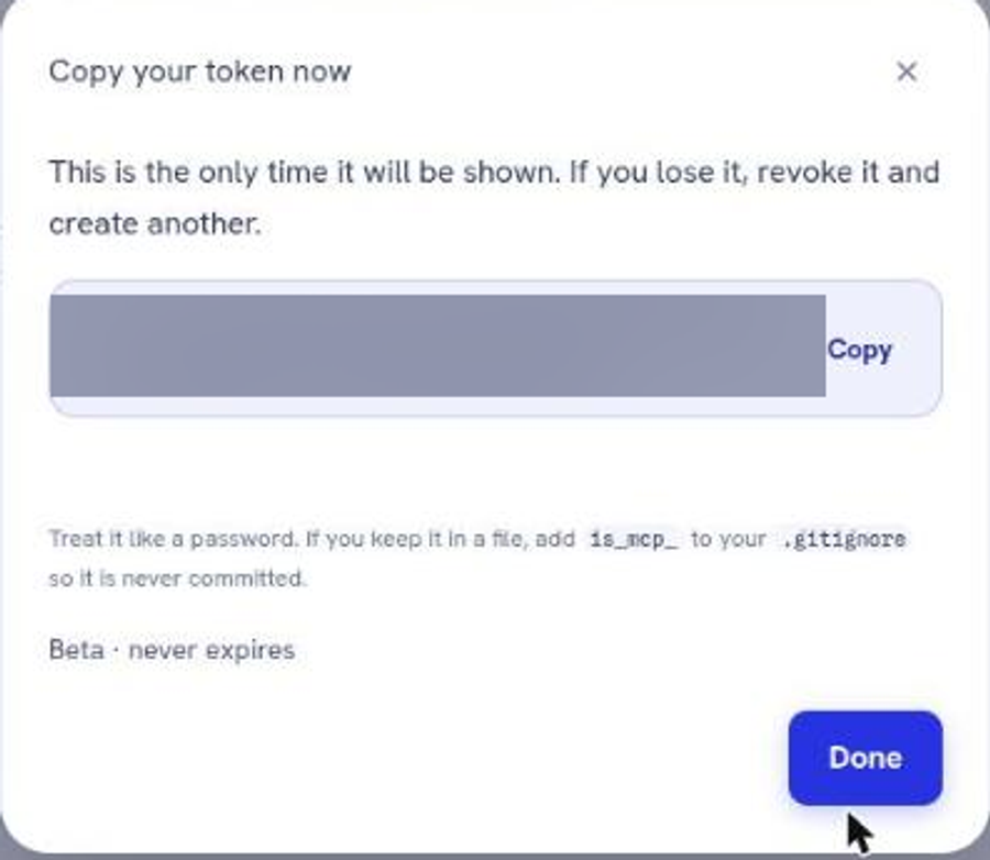 The token reveal dialog, with the value blurred, warning that this is the only time it will be shown