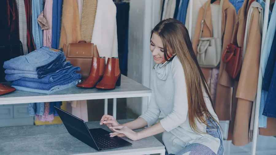 A boutique owner running her shop online from a laptop
